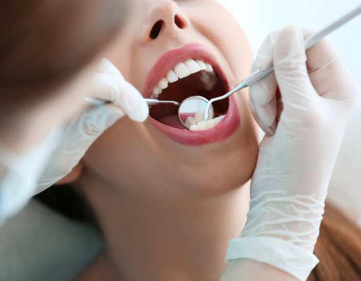 dentist checking woman's teeth