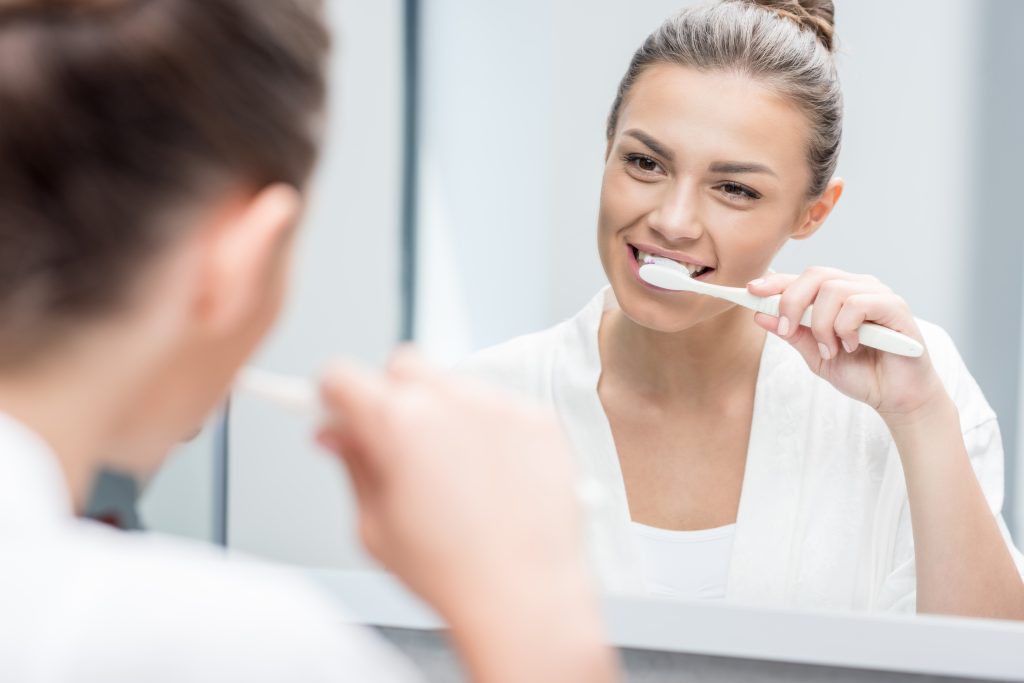 woman brushing teeth