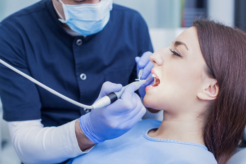dentist checking a woman's teeth