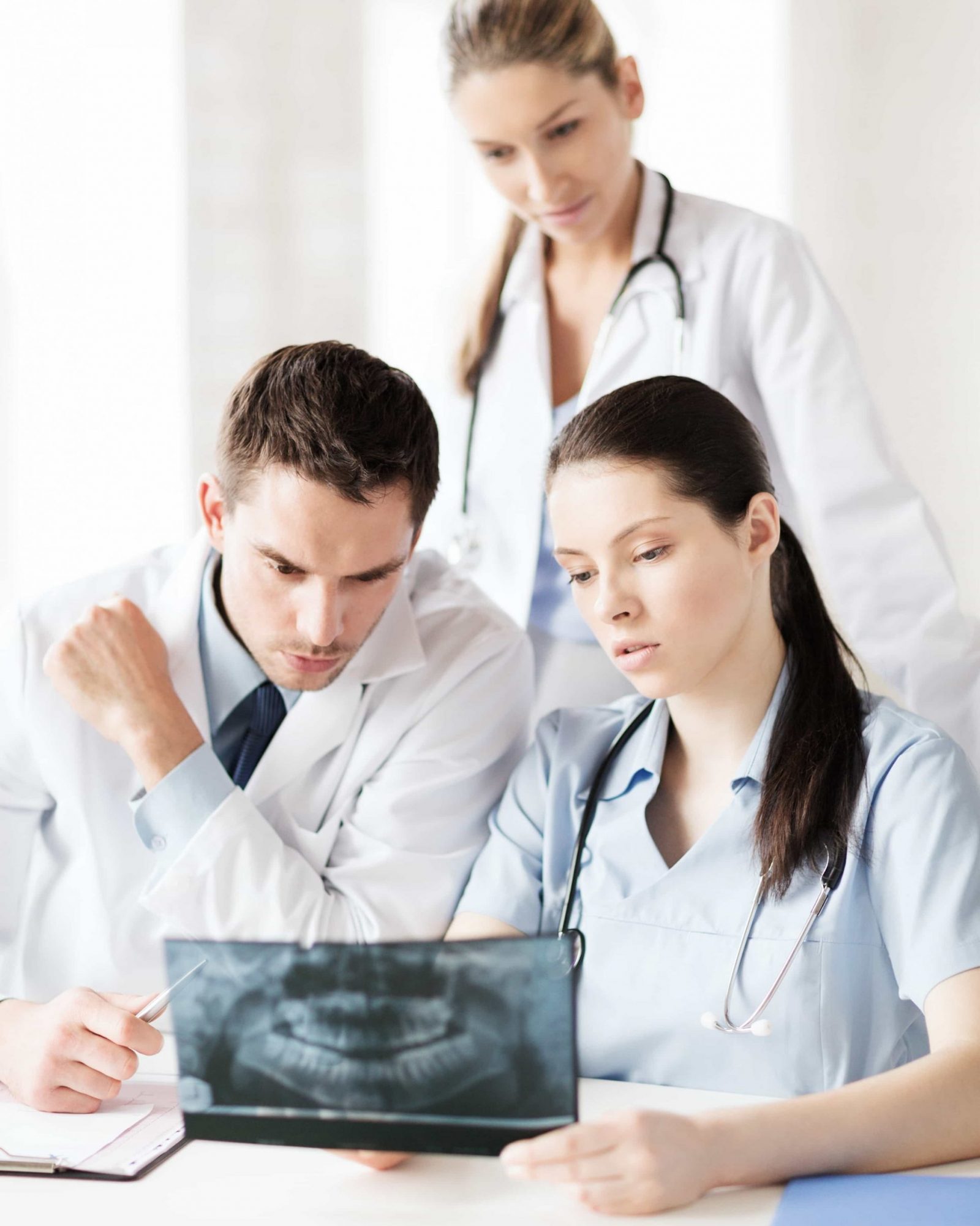 specialists looking at dental x ray